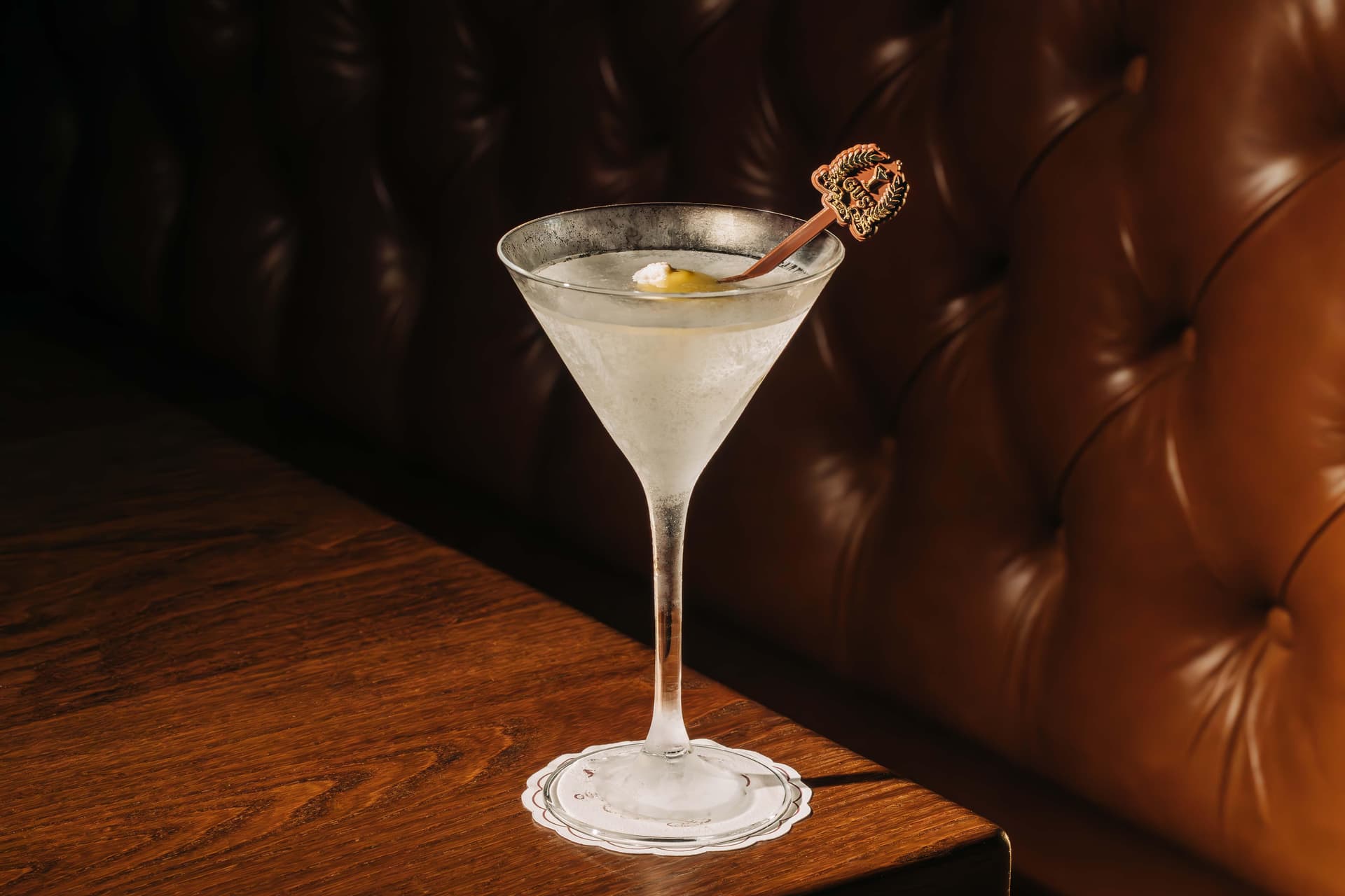 frosted martini glass placed on a wooden table